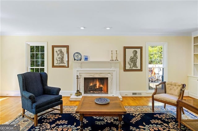 5655 Errol Pl NW, Atlanta, GA 30327 - sitting room with ornamental molding, visible vents, wood finished floors, and a healthy amount of sunlight