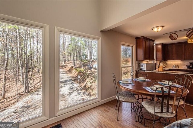 227 River Ridge Rd S, Dahlonega, GA 30533 - kitchen with tasteful backsplash, light stone countertops, appliances with stainless steel finishes, and a sink
