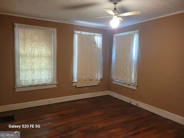 unfurnished room featuring ceiling fan, baseboards, dark wood-style floors, ornamental molding, and a wealth of natural light