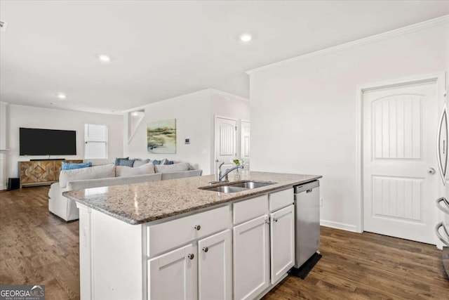 kitchen with a sink, stainless steel dishwasher, a kitchen island with sink, light stone countertops, and white cabinetry