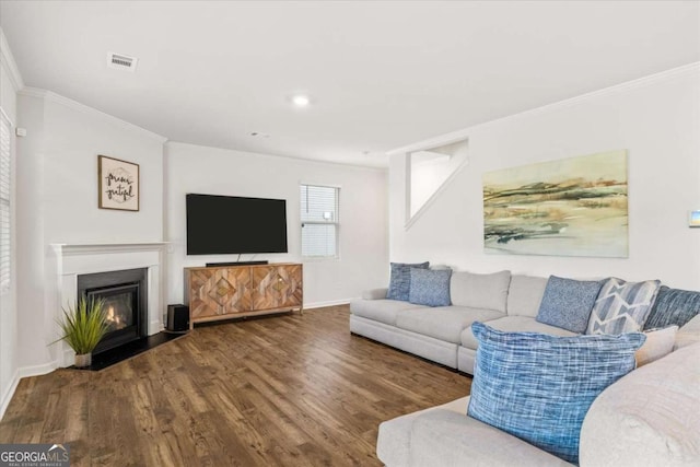 living area featuring ornamental molding, wood finished floors, baseboards, a fireplace with flush hearth, and recessed lighting