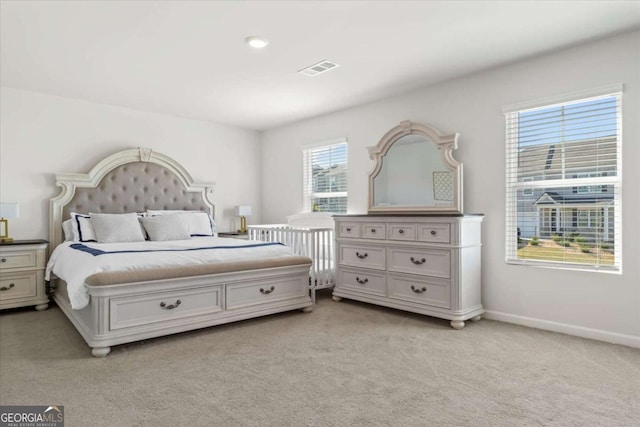 bedroom featuring light colored carpet and baseboards