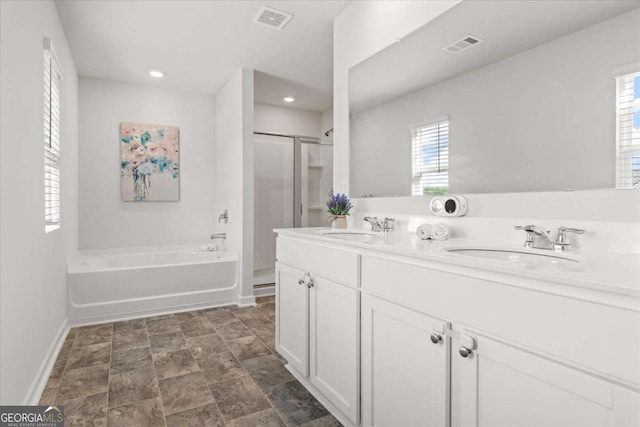 bathroom featuring baseboards, plenty of natural light, a stall shower, a bath, and recessed lighting
