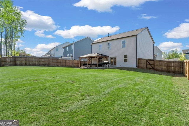 rear view of property with a gazebo and a patio