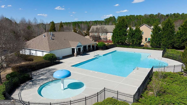 community pool featuring fence and a patio area