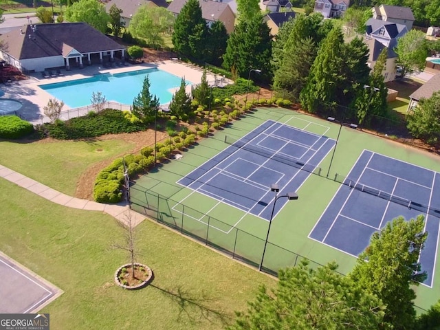 aerial perspective of suburban area featuring a pool