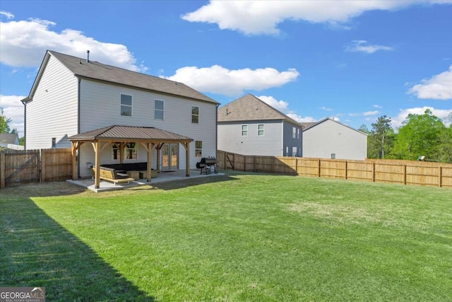 rear view of property featuring a gazebo and a patio