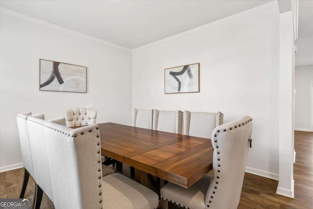 dining area with baseboards, ornamental molding, and wood finished floors
