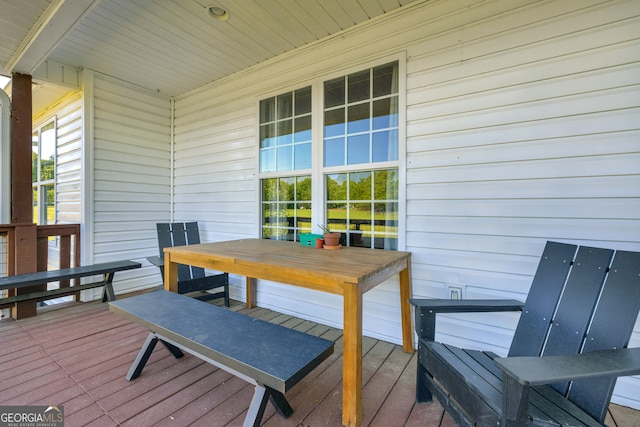 wooden terrace with outdoor dining space