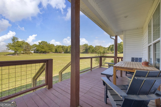 wooden terrace featuring a lawn