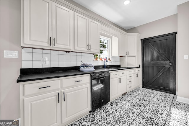 kitchen featuring white cabinetry, dark countertops, and dishwasher