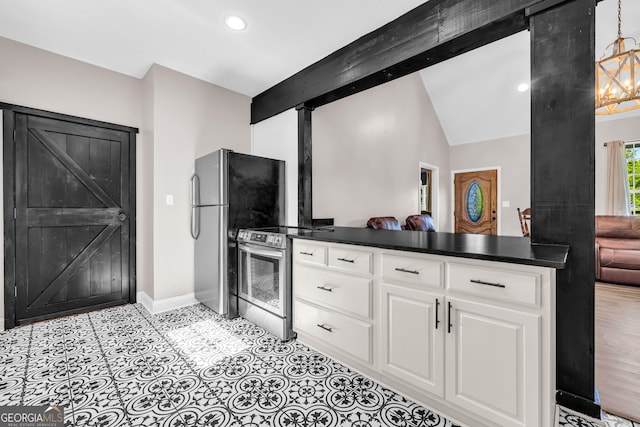 kitchen featuring white cabinets, dark countertops, stainless steel appliances, baseboards, and vaulted ceiling with beams