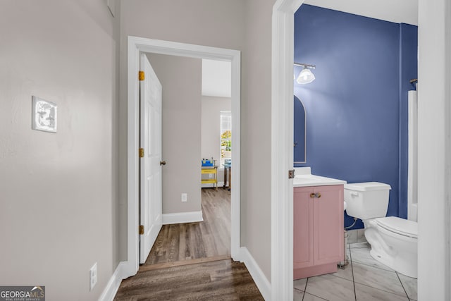 hallway with light wood-style floors and baseboards