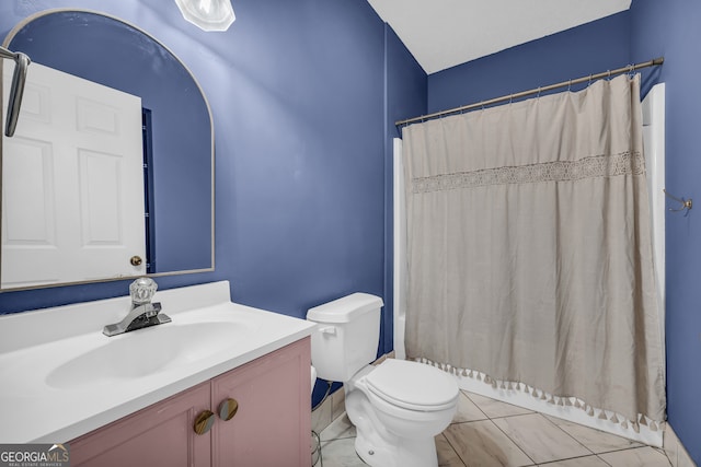 bathroom with toilet, vanity, a shower with shower curtain, and marble finish floor