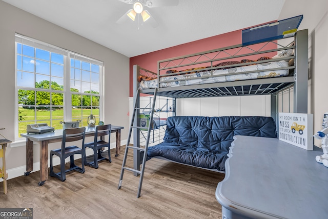 bedroom with wood finished floors, ceiling fan, and baseboards
