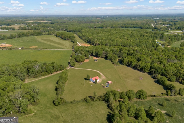 birds eye view of property featuring a rural view and a view of trees