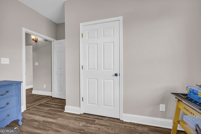 bedroom featuring dark wood-style floors and baseboards