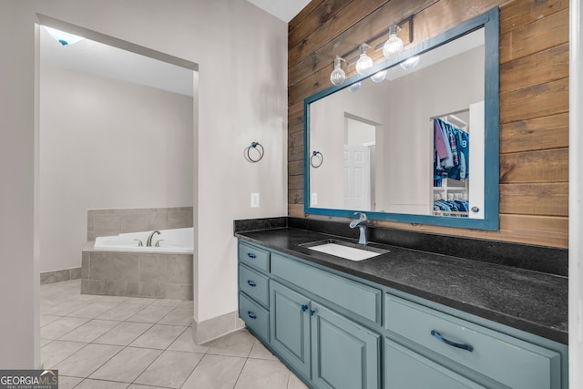 bathroom with a garden tub, tile patterned flooring, and vanity