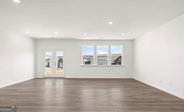 unfurnished living room featuring a wealth of natural light, wood finished floors, and recessed lighting