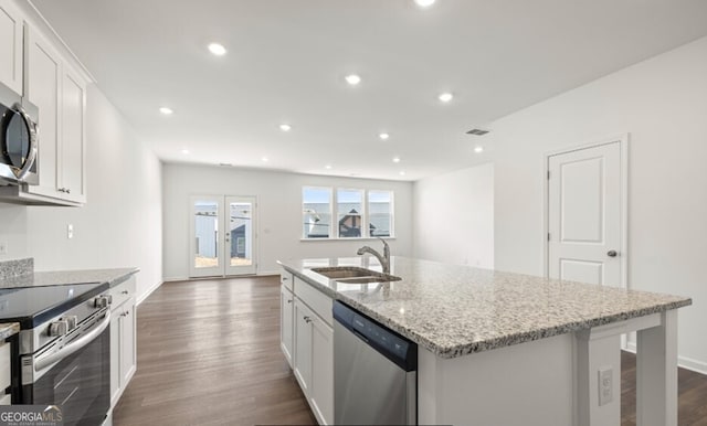 kitchen with white cabinets, dark wood-style flooring, appliances with stainless steel finishes, and a sink