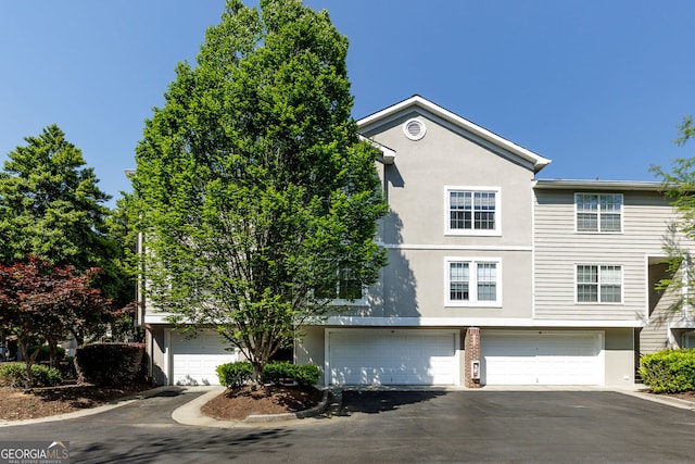 4246 River Green Dr Unit 202, Atlanta, GA 30327 - multi unit property with stucco siding, a garage, and asphalt driveway