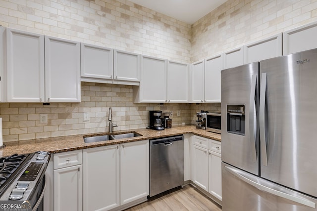 4246 River Green Dr Unit 202, Atlanta, GA 30327 - kitchen featuring stainless steel appliances, white cabinets, and light stone countertops
