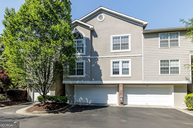 4246 River Green Dr Unit 202, Atlanta, GA 30327 - townhome / multi-family property featuring stucco siding, driveway, and an attached garage