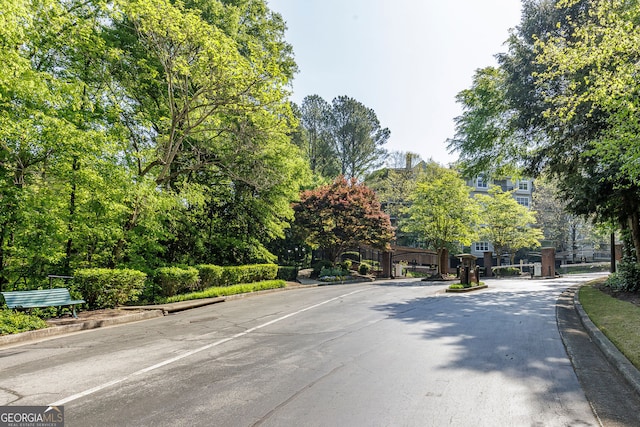 4246 River Green Dr Unit 202, Atlanta, GA 30327 - view of asphalt street with curbs and a gated entry