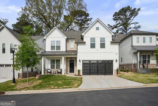 modern farmhouse style home with a garage, a porch, a standing seam roof, and concrete driveway