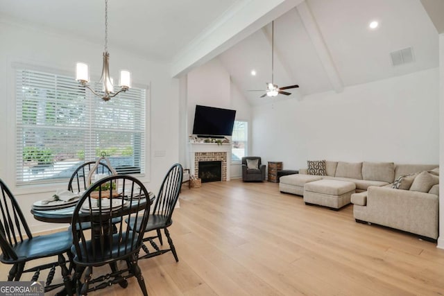 dining area featuring plenty of natural light, visible vents, light wood-style floors, beam ceiling, and ceiling fan with notable chandelier