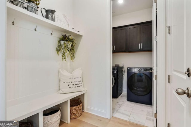 mudroom with baseboards, marble finish floor, and washer and dryer