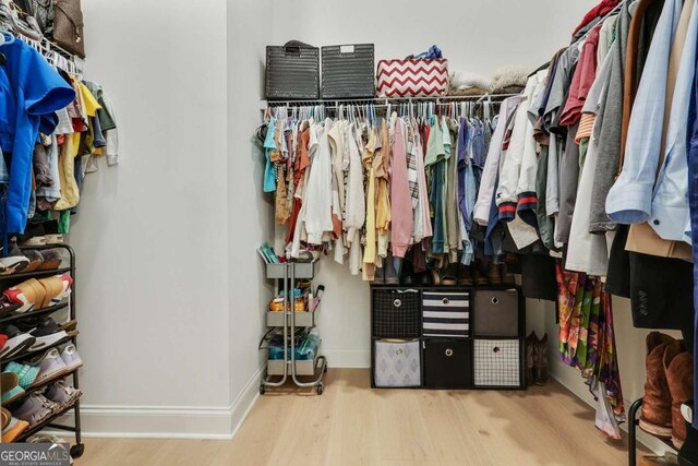 walk in closet featuring wood finished floors