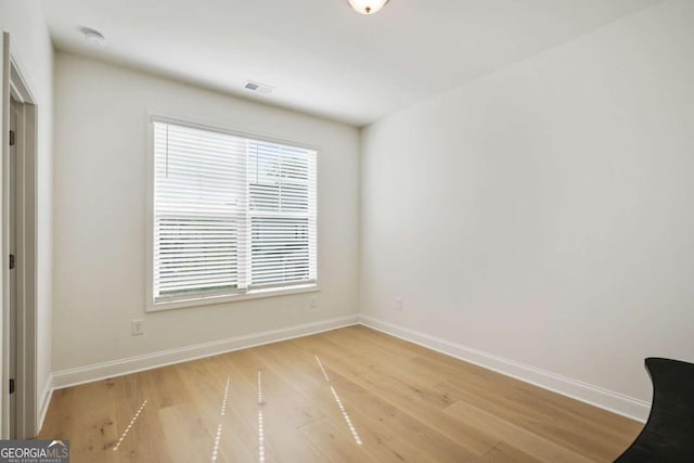 interior space featuring baseboards, visible vents, and light wood-style flooring