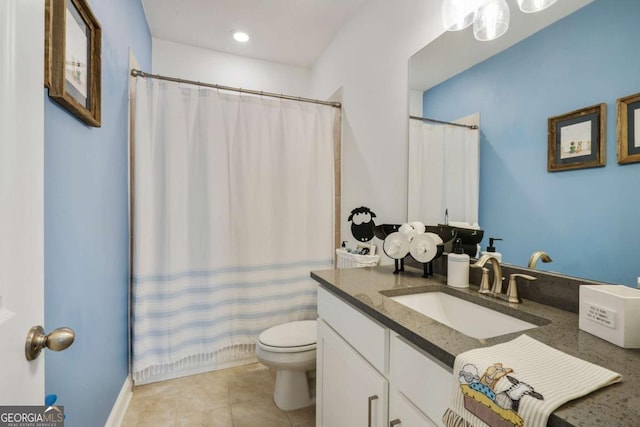 bathroom with tile patterned flooring, toilet, vanity, and curtained shower