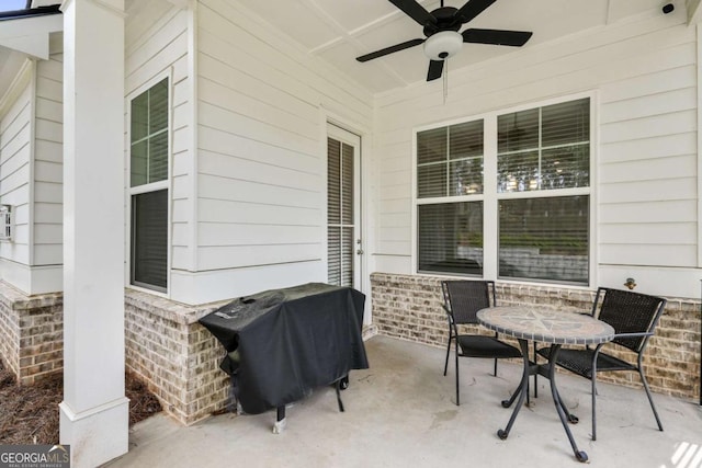 view of patio featuring a grill, outdoor dining space, and ceiling fan
