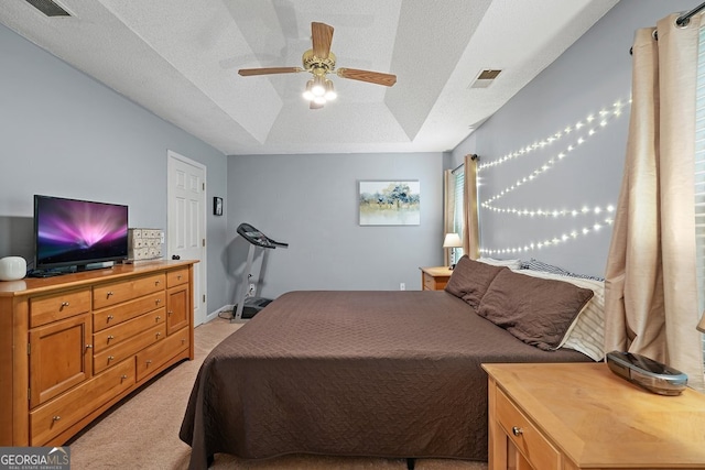 bedroom featuring light colored carpet, a ceiling fan, and visible vents
