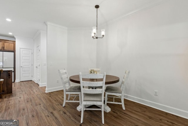 166 Verano St, Kingsland, GA 31548 - dining area featuring crown molding, dark wood-type flooring, recessed lighting, and a chandelier
