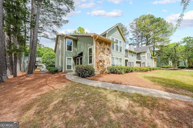 1206 Canyon Point Cir, Roswell, GA 30076 - view of front facade with stone siding and a front lawn