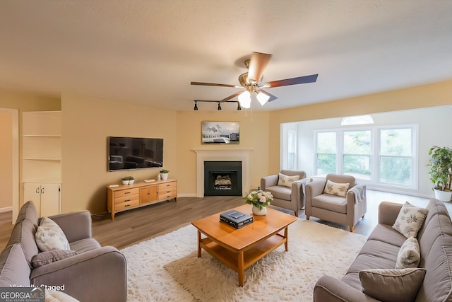 1206 Canyon Point Cir, Roswell, GA 30076 - living room with a fireplace, track lighting, wood finished floors, and a ceiling fan