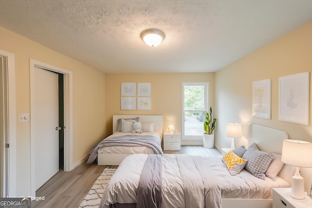 1206 Canyon Point Cir, Roswell, GA 30076 - bedroom featuring light wood-style flooring, a textured ceiling, and baseboards