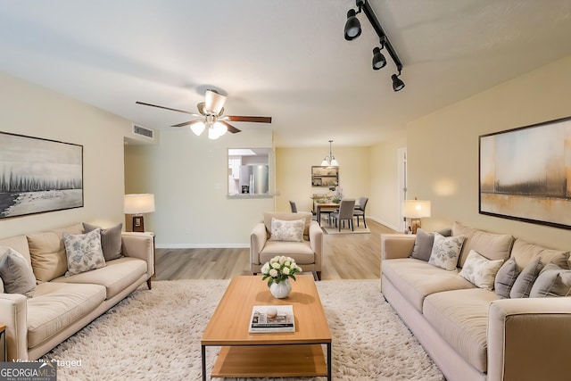 1206 Canyon Point Cir, Roswell, GA 30076 - living area with wood finished floors, rail lighting, visible vents, a ceiling fan, and baseboards