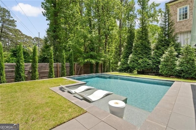 view of swimming pool featuring a yard, a fenced in pool, and a fenced backyard