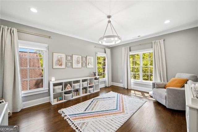 sitting room featuring wood finished floors, baseboards, and a wealth of natural light