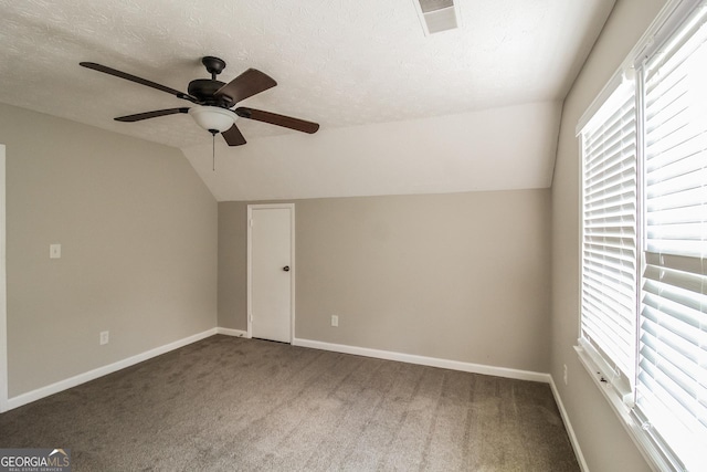 6024 S Deshon Ct, Lithonia, GA 30058 - carpeted empty room featuring lofted ceiling, healthy amount of natural light, ceiling fan, and a textured ceiling