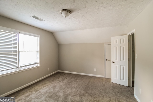 6024 S Deshon Ct, Lithonia, GA 30058 - bonus room with carpet floors, a textured ceiling, and vaulted ceiling