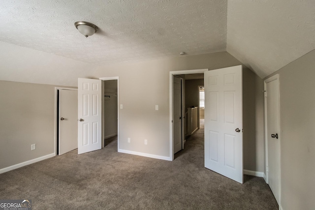 6024 S Deshon Ct, Lithonia, GA 30058 - unfurnished bedroom featuring lofted ceiling, dark carpet, a textured ceiling, and a closet