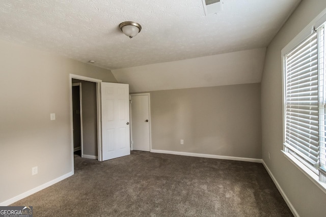 6024 S Deshon Ct, Lithonia, GA 30058 - unfurnished bedroom with multiple windows, carpet flooring, a textured ceiling, lofted ceiling, and a closet