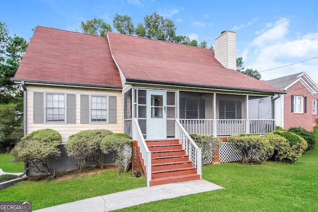 6024 S Deshon Ct, Lithonia, GA 30058 - view of front of home with a sunroom, a chimney, a front lawn, and roof with shingles