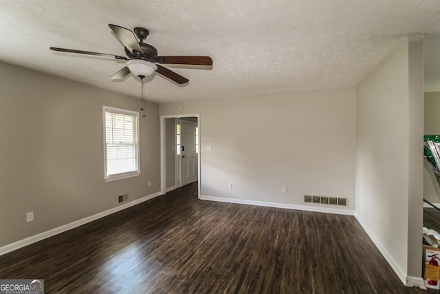 6024 S Deshon Ct, Lithonia, GA 30058 - empty room with ceiling fan, dark wood finished floors, and a textured ceiling