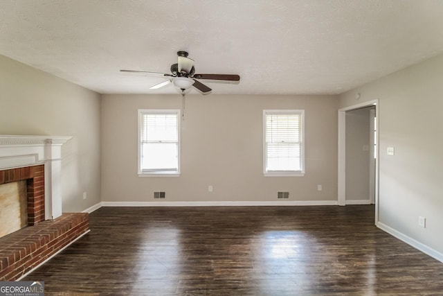 6024 S Deshon Ct, Lithonia, GA 30058 - unfurnished living room featuring healthy amount of natural light, a ceiling fan, a brick fireplace, and dark wood finished floors